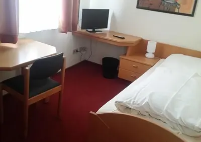Ein Bett oder Betten in einem Zimmer der Unterkunft Schwäbischer Hof