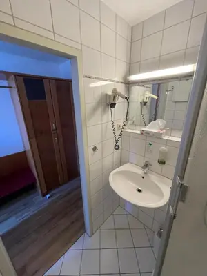 Ein Badezimmer in der Unterkunft City Pension