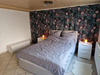 Ein Bett oder Betten in einem Zimmer der Unterkunft Ferienwohnung Blumenshein bei Speyer Karlsruhe Familienfreundlich 5 Pers