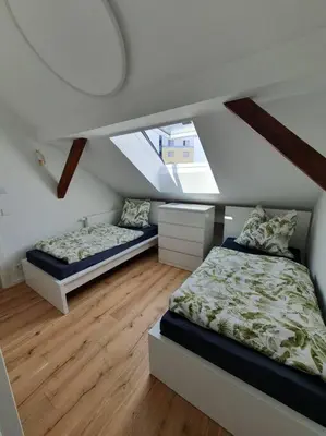 Ein Bett oder Betten in einem Zimmer der Unterkunft 4.OG/Maisonette-Wohnung neu/4-Zimmer/Weststadt