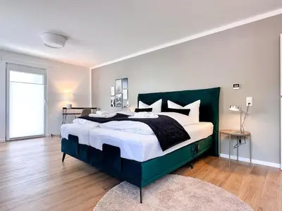 Ein Bett oder Betten in einem Zimmer der Unterkunft Appartio: Geräumige, moderne Ferienwohnung für Gruppen/Familien