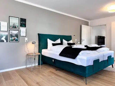 Ein Bett oder Betten in einem Zimmer der Unterkunft Appartio: Geräumige, moderne Ferienwohnung für Gruppen/Familien