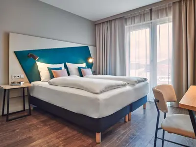 Ein Bett oder Betten in einem Zimmer der Unterkunft Aparthotel Adagio Heidelberg