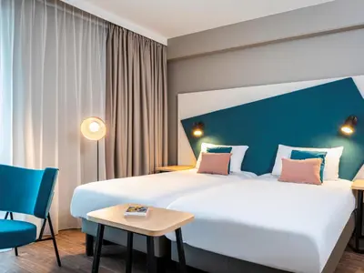 Ein Bett oder Betten in einem Zimmer der Unterkunft Aparthotel Adagio Heidelberg