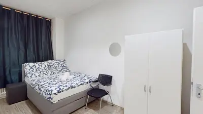 Ein Bett oder Betten in einem Zimmer der Unterkunft Garten Gästehaus
