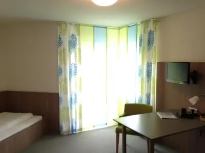 Ein Bett oder Betten in einem Zimmer der Unterkunft Hotel Astra Rastatt