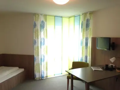 Ein Bett oder Betten in einem Zimmer der Unterkunft Hotel Astra Rastatt