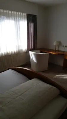 Ein Bett oder Betten in einem Zimmer der Unterkunft Hotel Büchner Garni