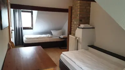 Ein Bett oder Betten in einem Zimmer der Unterkunft Gästehaus Zu Herrenwiesen