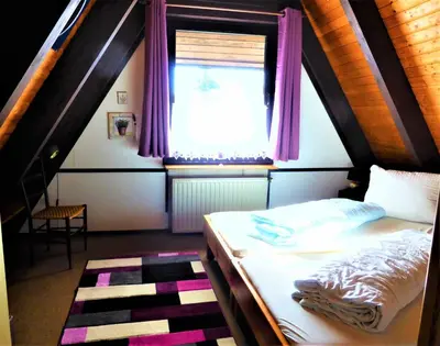 Ein Bett oder Betten in einem Zimmer der Unterkunft Ferienhaus Winnetou Im Abendrot 124