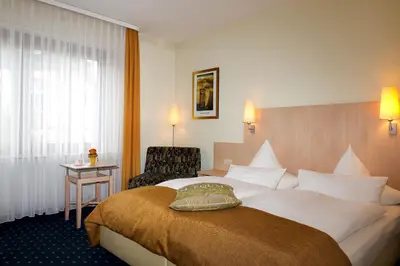 Ein Bett oder Betten in einem Zimmer der Unterkunft Hotel Deutsches Haus