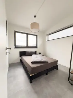 Ein Bett oder Betten in einem Zimmer der Unterkunft Apart das Ehrets mit 3 Schlafzimmer