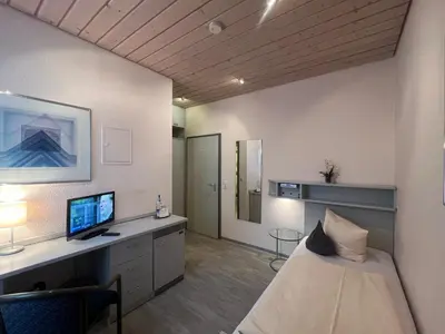 Ein Bett oder Betten in einem Zimmer der Unterkunft Hotel Cronberger Hof