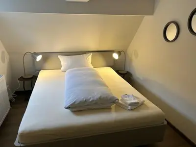 Ein Bett oder Betten in einem Zimmer der Unterkunft Krönchen