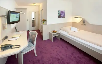 Ein Bett oder Betten in einem Zimmer der Unterkunft Hotel Malchen Garni