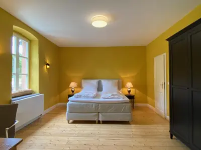 Ein Bett oder Betten in einem Zimmer der Unterkunft Ferienhaus Leon im Schloss und Hofgut Langenzell