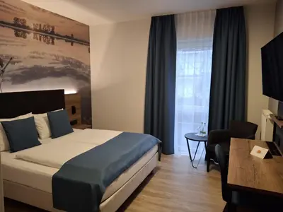 Ein Bett oder Betten in einem Zimmer der Unterkunft Hotel am Hardtsee
