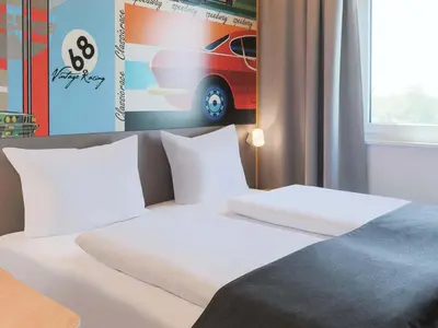 Ein Bett oder Betten in einem Zimmer der Unterkunft B&B HOTEL Bruchsal-Karlsdorf