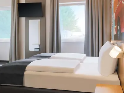 Ein Bett oder Betten in einem Zimmer der Unterkunft B&B HOTEL Bruchsal-Karlsdorf
