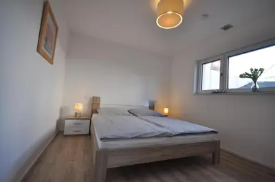 Ein Bett oder Betten in einem Zimmer der Unterkunft Ferienwohnung Schwind in Weyher in der Pfalz