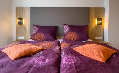 Ein Bett oder Betten in einem Zimmer der Unterkunft Hotel Restaurant Traube Kallstadt