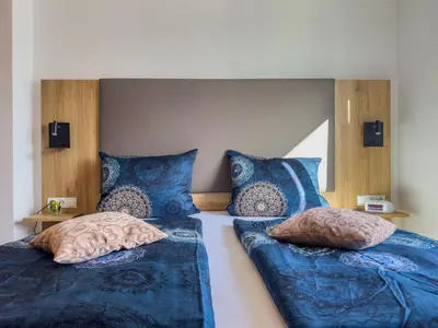 Ein Bett oder Betten in einem Zimmer der Unterkunft Hotel Restaurant Traube Kallstadt