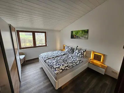 Ein Bett oder Betten in einem Zimmer der Unterkunft Ferienwohnung am Heuberg