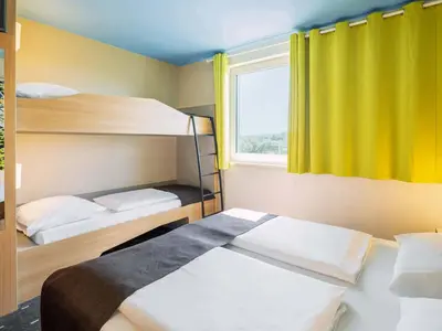 Ein Bett oder Betten in einem Zimmer der Unterkunft B&B Hotel Karlsruhe