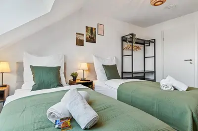 Ein Bett oder Betten in einem Zimmer der Unterkunft Zentral - 4 Schlafzimmer - Küche - Waschmaschine