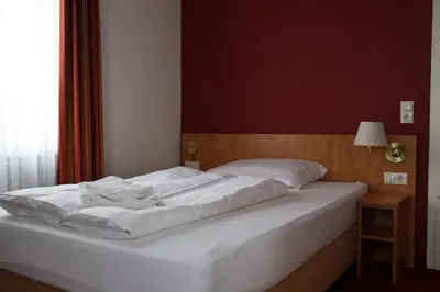 Ein Bett oder Betten in einem Zimmer der Unterkunft Hotel an der Therme