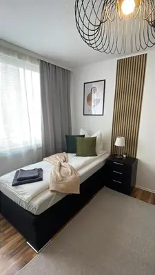 Ein Bett oder Betten in einem Zimmer der Unterkunft Charmantes Familienrefugium im Zentrum von Ludwigshafen - Eleganz & Komfort Ideal fur Familien