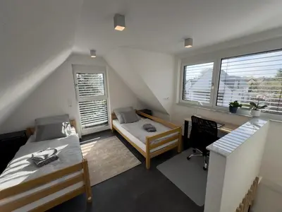 Ein Bett oder Betten in einem Zimmer der Unterkunft Moderne Maisonette-Wohnung