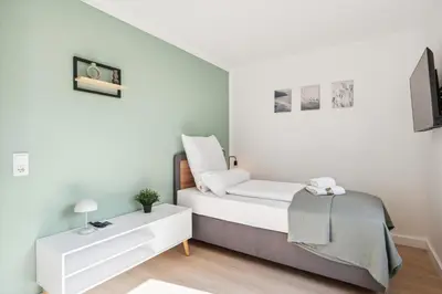 Ein Bett oder Betten in einem Zimmer der Unterkunft Sali Homes Weingenuss Eichbrunnen - Zentral
