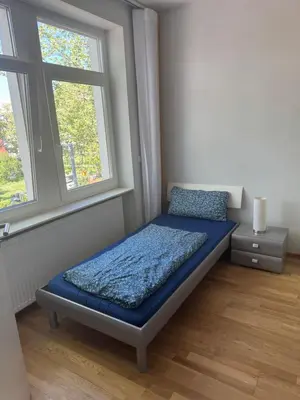Ein Bett oder Betten in einem Zimmer der Unterkunft Zentrale 4 Zimmerwohnung mit kostenlosem Stellplatz