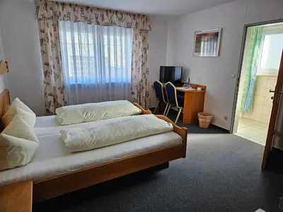 Ein Bett oder Betten in einem Zimmer der Unterkunft Hotel Gasthof Frohmüller