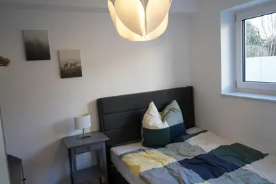 Ein Bett oder Betten in einem Zimmer der Unterkunft Ferienwohnungen Rosengarten