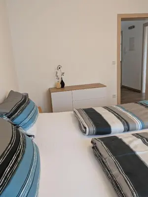 Ein Bett oder Betten in einem Zimmer der Unterkunft Ferienhaus Rauwolf mit 2 Ferienwohnungen