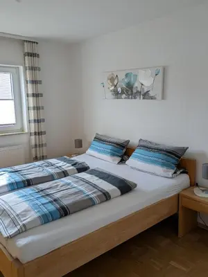 Ein Bett oder Betten in einem Zimmer der Unterkunft Ferienhaus Rauwolf mit 2 Ferienwohnungen
