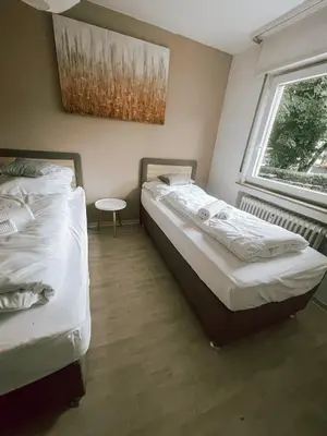 Ein Bett oder Betten in einem Zimmer der Unterkunft DoreyHome HN1 - Stilvolles Apartment zentral in Heilbronn - 7 Personen - WLAN
