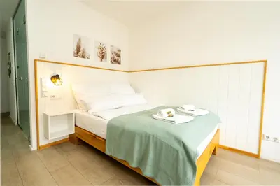 Ein Bett oder Betten in einem Zimmer der Unterkunft Sali Homes Apartmenthaus Schlossgasse
