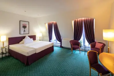 Ein Bett oder Betten in einem Zimmer der Unterkunft Hotel Artrium am Park