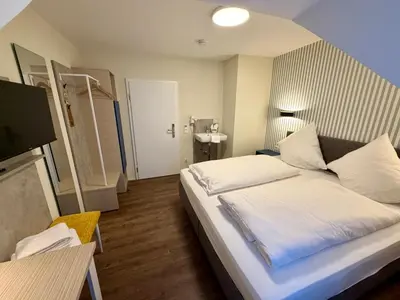 Ein Bett oder Betten in einem Zimmer der Unterkunft Hotel Am Kornmarkt