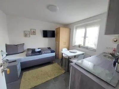 Ein Bett oder Betten in einem Zimmer der Unterkunft Boardinghouse Wildbachtal