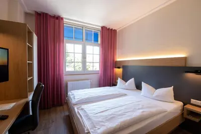 Ein Bett oder Betten in einem Zimmer der Unterkunft Hotel Avisa