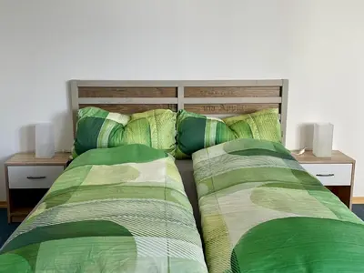 Ein Bett oder Betten in einem Zimmer der Unterkunft -Am Pfühlpark- Ferienwohnung