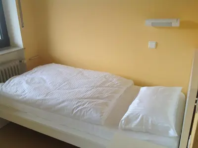 Ein Bett oder Betten in einem Zimmer der Unterkunft Hotel-Pension Schlossgarten