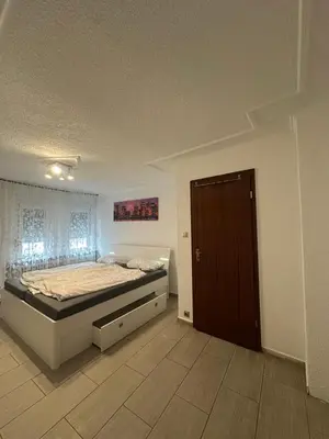 Ein Bett oder Betten in einem Zimmer der Unterkunft Shekinah Residences near Frankfurt Airport