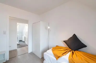 Ein Bett oder Betten in einem Zimmer der Unterkunft 2 Zimmer Dachstudio Apartment mit 4 Einzelbetten