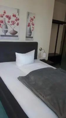 Ein Bett oder Betten in einem Zimmer der Unterkunft Hotel Restaurant Erbprinz Walldorf