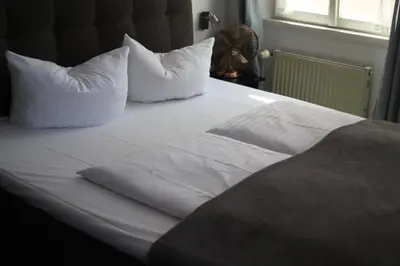 Ein Bett oder Betten in einem Zimmer der Unterkunft Hotel Restaurant Erbprinz Walldorf